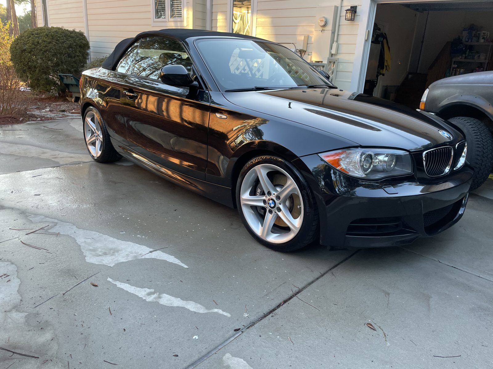 Black BMW 135i convertible with mirror gloss after mobile detailing in Brunswick County NC