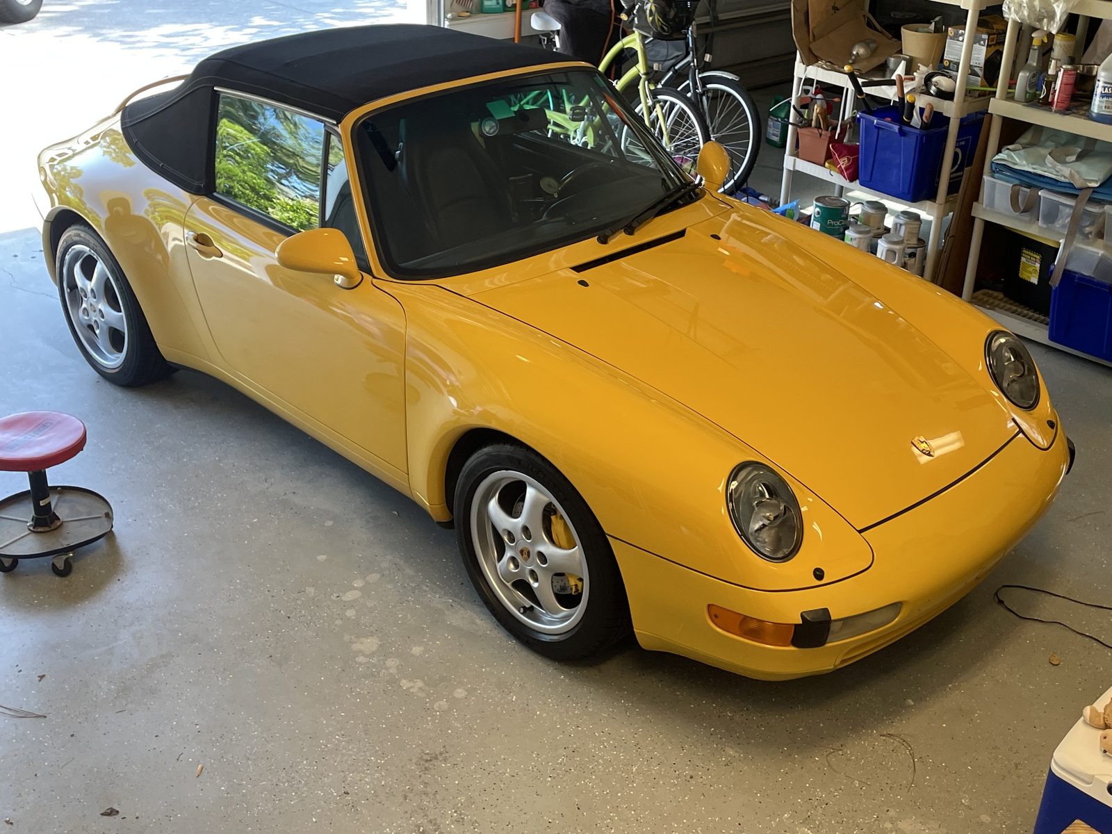 Yellow Porsche 993 cabriolet detailed in a garage near Southport NC
